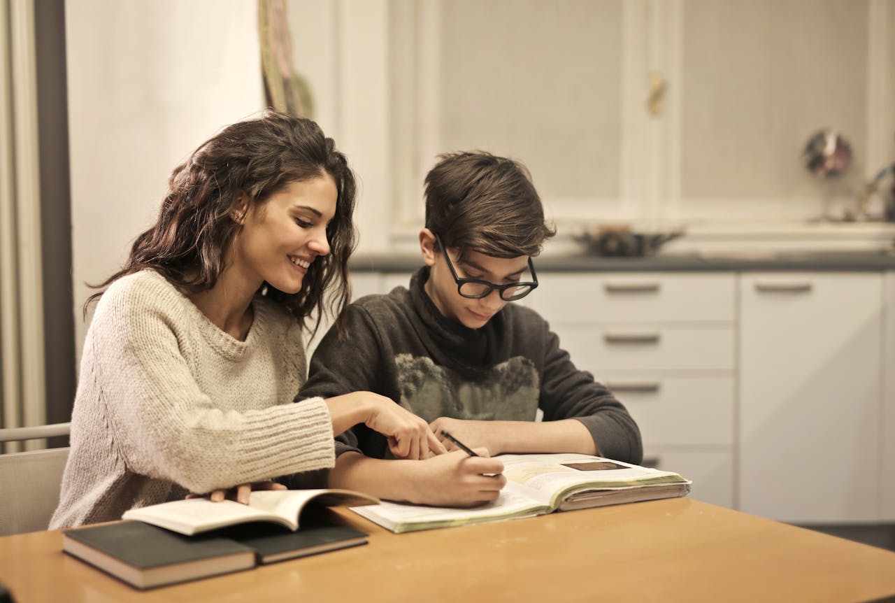 Brother and sister studying together at home, focusing on homework and learning.